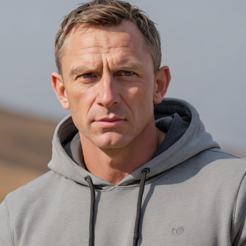 Man wearing a gray hoodie with a blurred background